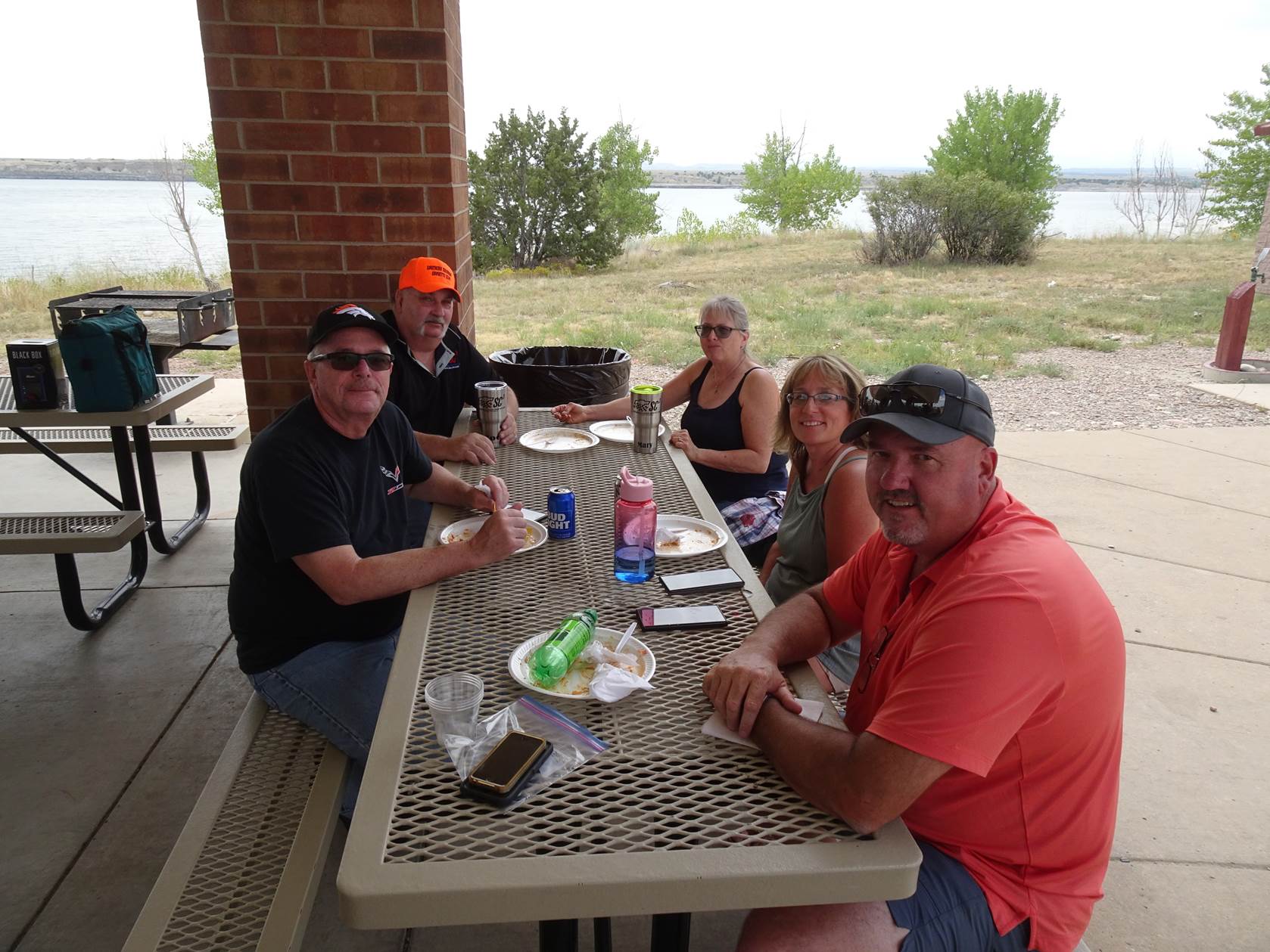 A group of people sitting around a table with food on it

Description automatically generated with medium confidence