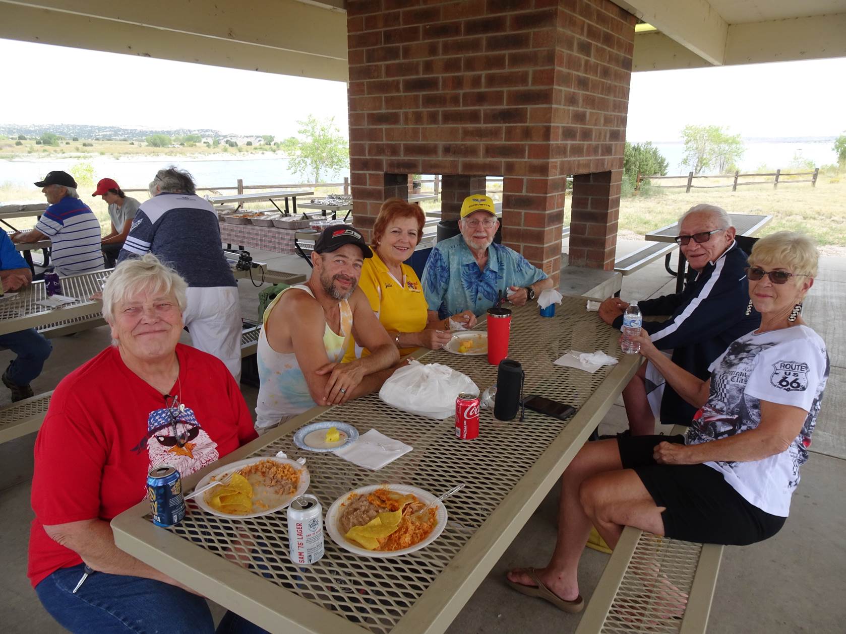 A group of people sitting around a table with food on it

Description automatically generated with medium confidence