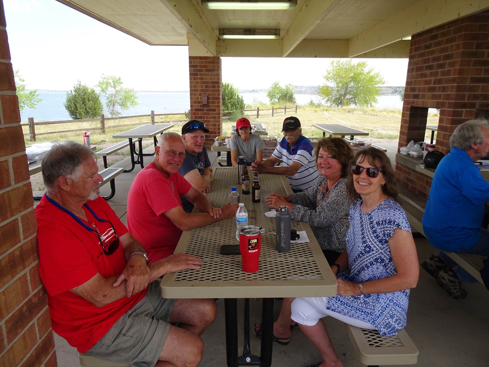 A group of people sitting at a table outside

Description automatically generated with medium confidence