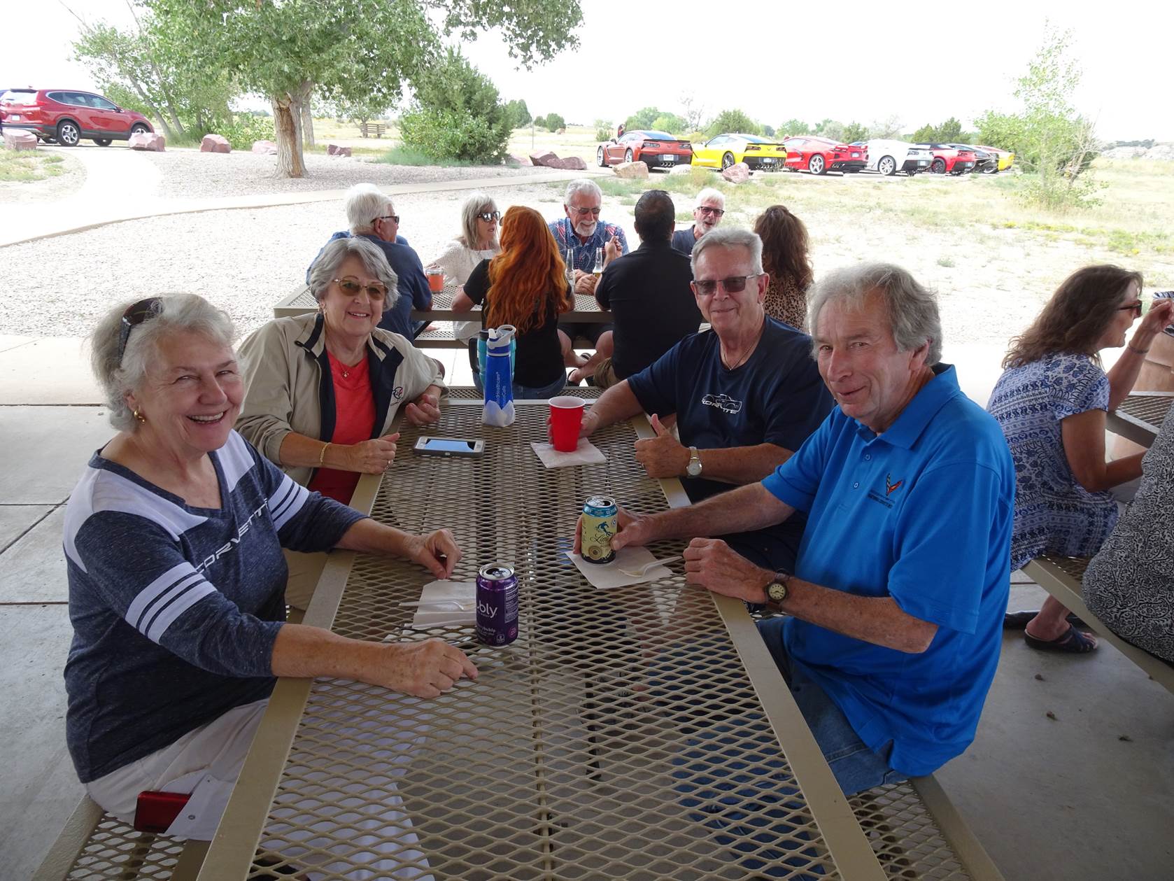 A group of people sitting around a table outside

Description automatically generated with medium confidence