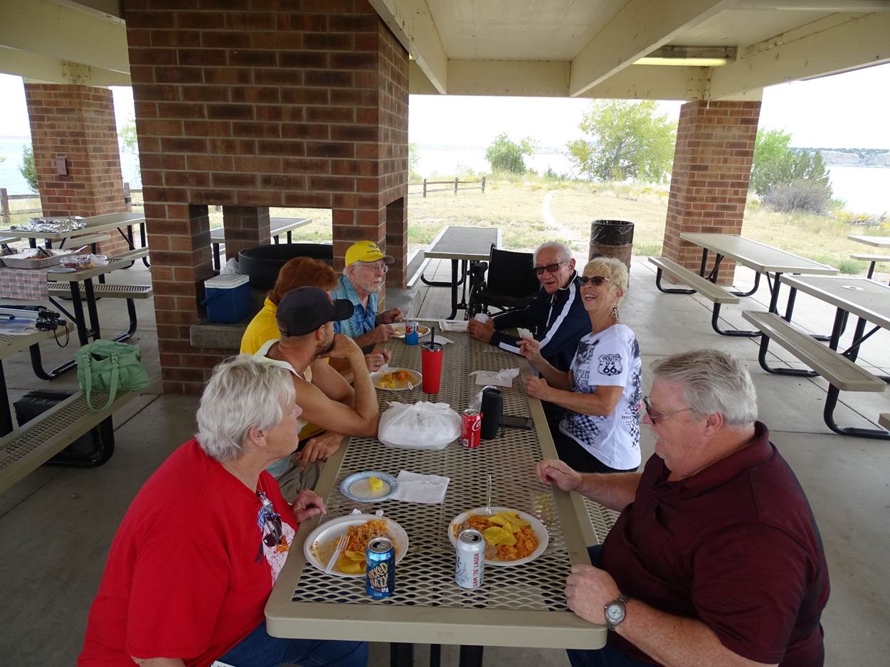 A group of people gather around a table

Description automatically generated with low confidence