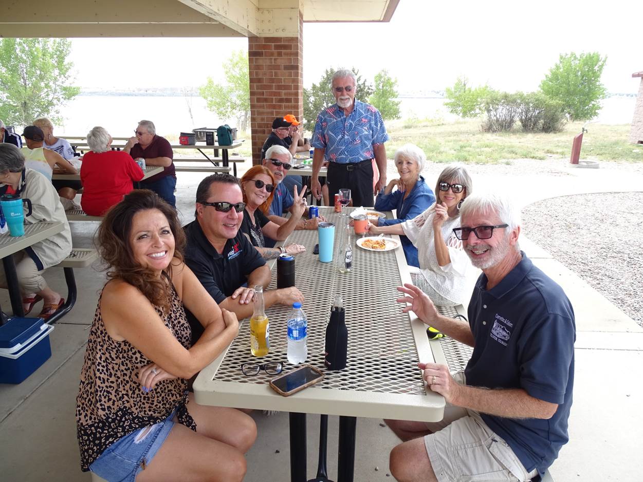 A group of people sitting at a table outside

Description automatically generated with medium confidence