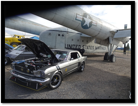 A car with the hood open next to a plane

AI-generated content may be incorrect.