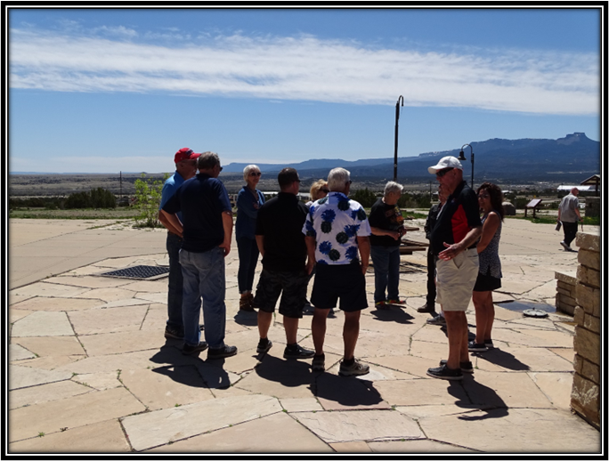 A group of people standing on a stone surface

Description automatically generated with medium confidence