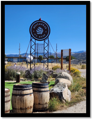 A sign with a barrel in front of it

Description automatically generated