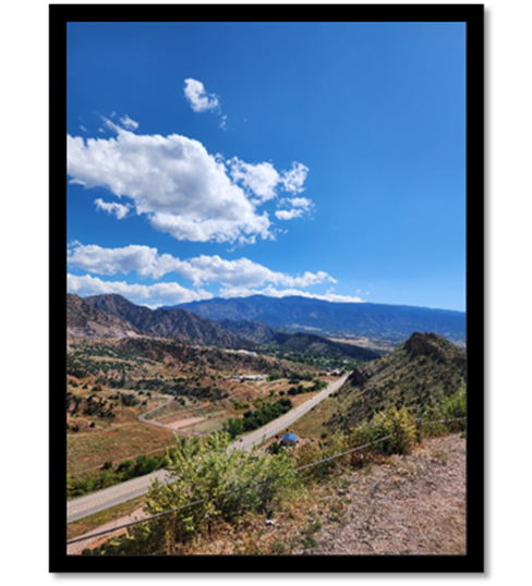 A road and mountains with blue sky

Description automatically generated