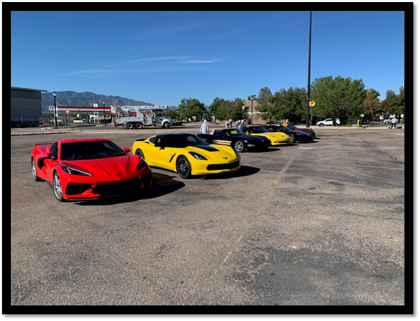 A group of cars parked in a parking lot

Description automatically generated
