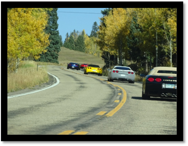 A group of cars on a road

Description automatically generated