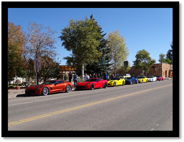 A row of cars parked on the side of the road

Description automatically generated