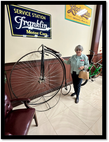 A person holding a large bicycle

AI-generated content may be incorrect.