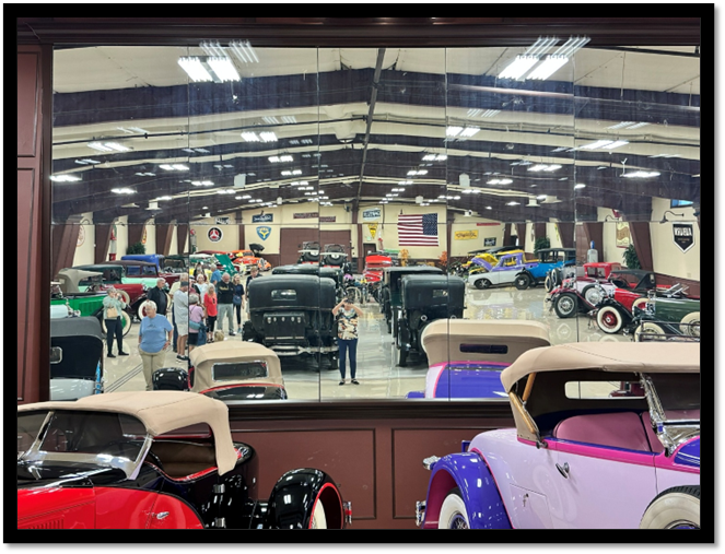 A group of people looking at cars in a building

AI-generated content may be incorrect.