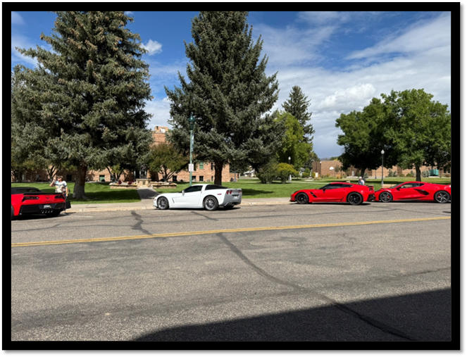 A red and white sports cars parked on the side of a road

AI-generated content may be incorrect.