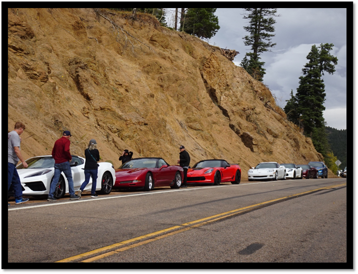 A group of cars parked on a road

AI-generated content may be incorrect.