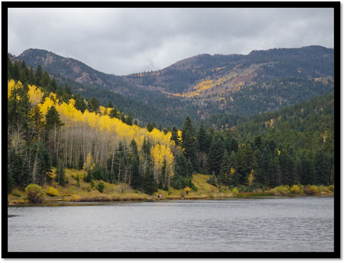 A lake with trees and mountains in the background

AI-generated content may be incorrect.