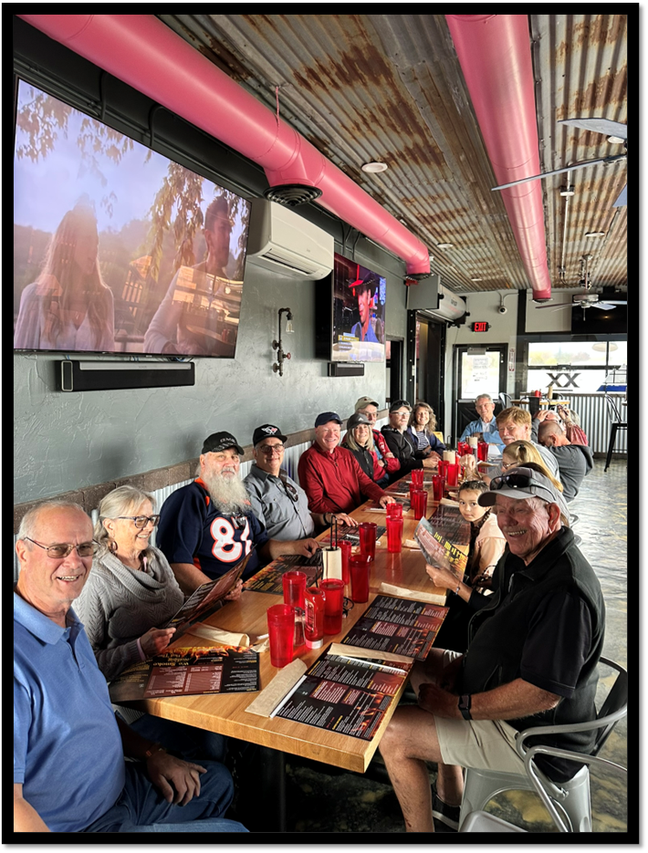 A group of people sitting at a table

AI-generated content may be incorrect.