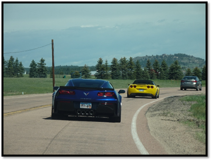 A blue and yellow sports cars on a road

AI-generated content may be incorrect.