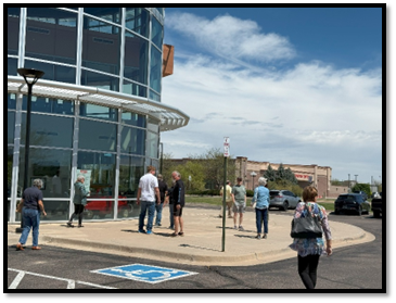 A group of people standing outside a building

AI-generated content may be incorrect.