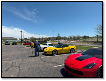 A person standing in a parking lot with cars

AI-generated content may be incorrect.