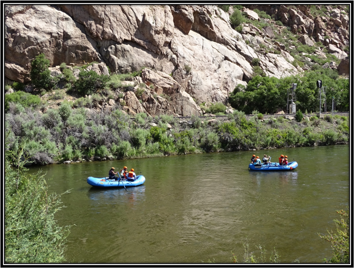 A group of people in rafts on a river

Description automatically generated