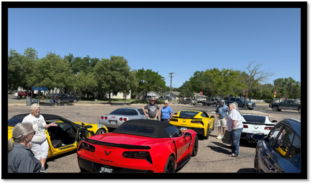 A group of people standing around a red and yellow sports car

AI-generated content may be incorrect.