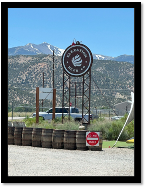 A sign with a mountain in the background