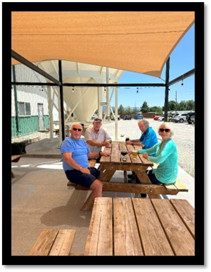 A group of people sitting at a picnic table

AI-generated content may be incorrect.
