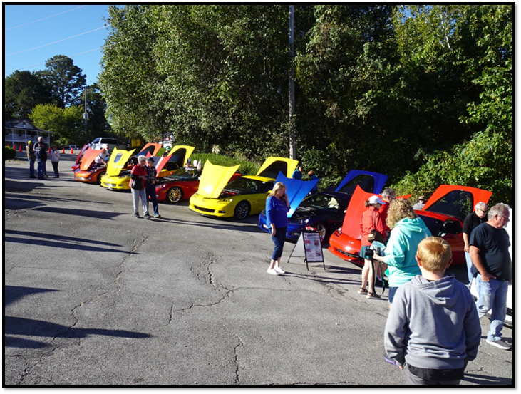 A group of people at a car show

Description automatically generated with low confidence