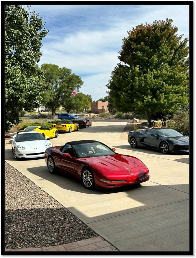 A group of cars parked in a driveway

AI-generated content may be incorrect.