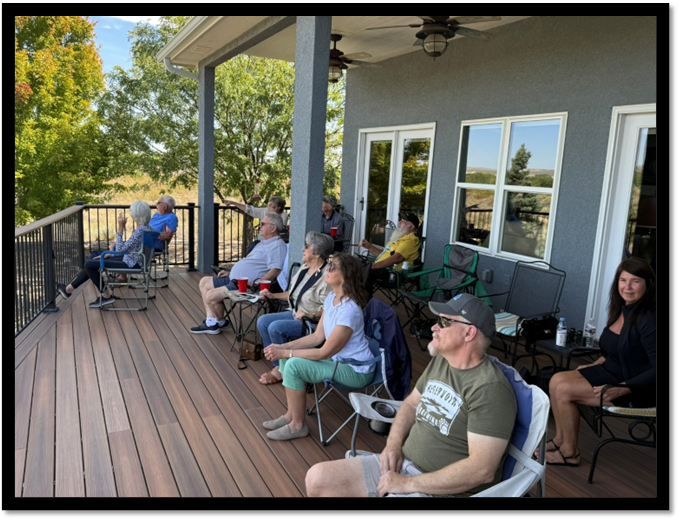 A group of people sitting on a deck

AI-generated content may be incorrect.