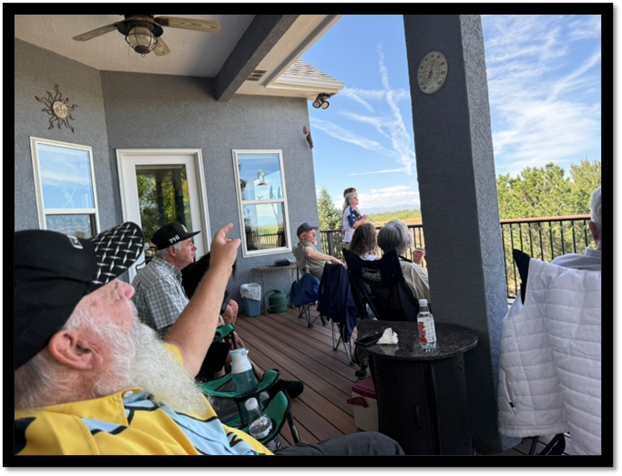 A group of people sitting on a porch

AI-generated content may be incorrect.