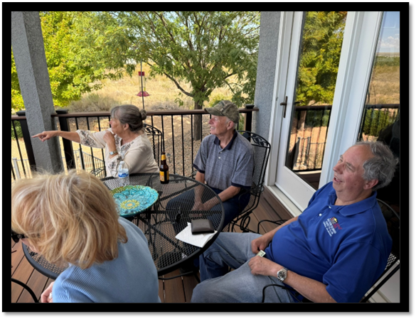 A group of people sitting at a table

AI-generated content may be incorrect.