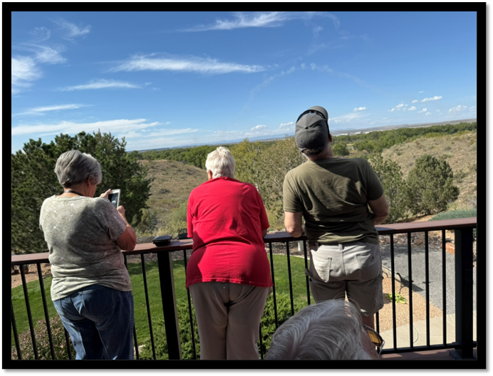 A group of people standing on a balcony looking at a landscape

AI-generated content may be incorrect.