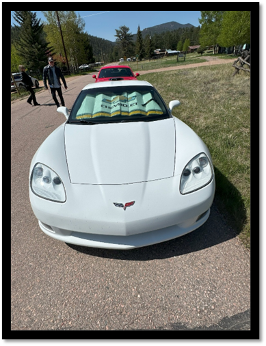 A white sports car parked on a road

AI-generated content may be incorrect.