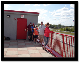 A group of people standing on a roof

Description automatically generated