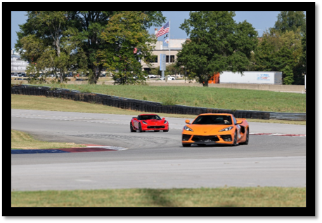 Two cars on a race track

Description automatically generated