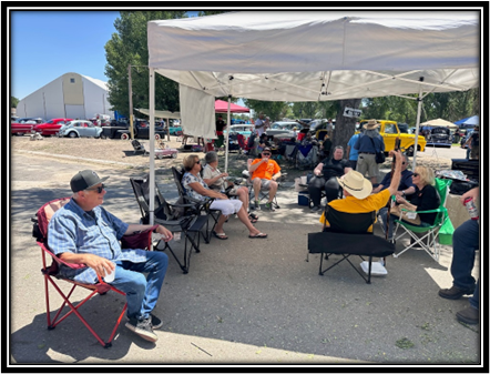 A group of people sitting under a white tent

Description automatically generated with medium confidence