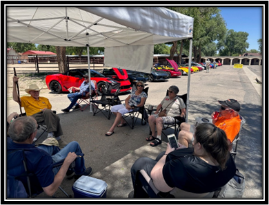 A group of people sitting under a white tent

Description automatically generated