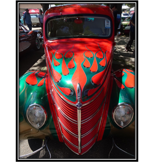 A red and green car with flames on the hood

Description automatically generated with medium confidence