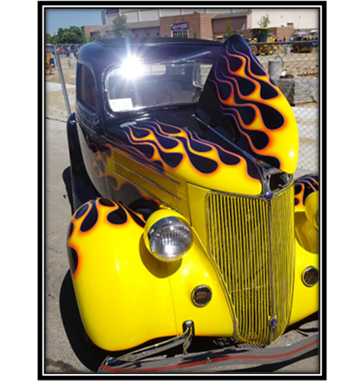 A yellow car with flames on it

Description automatically generated with low confidence
