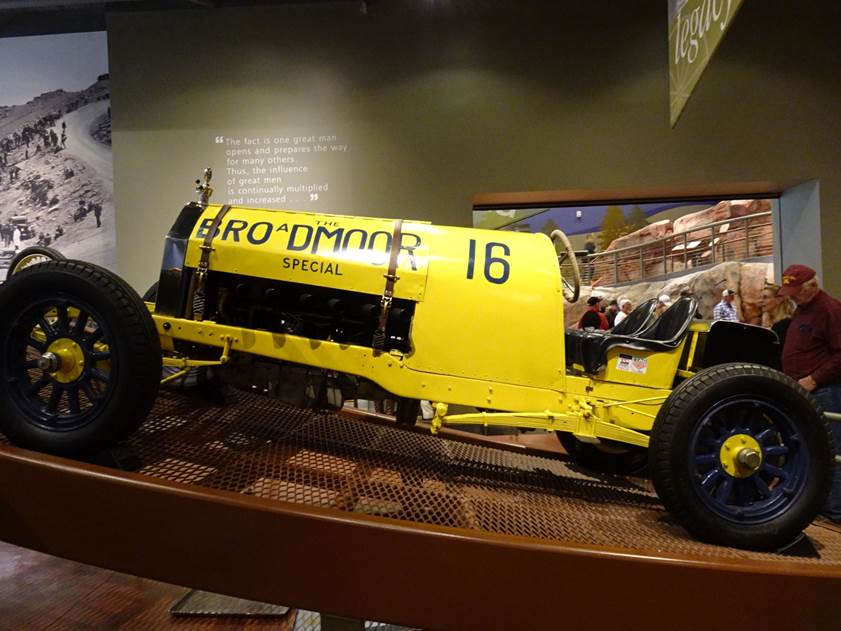 A yellow race car on display

Description automatically generated