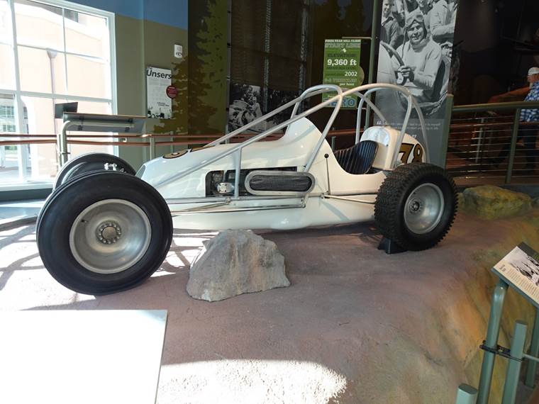 A white race car on display

Description automatically generated