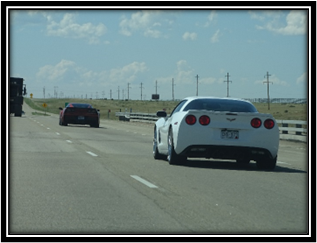 A white car on the road

Description automatically generated