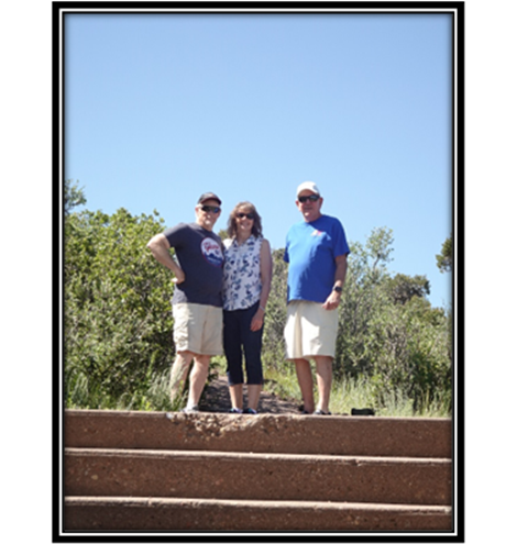 A group of people standing on steps

Description automatically generated