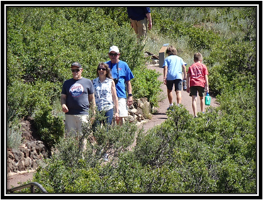 A group of people walking on a trail

Description automatically generated