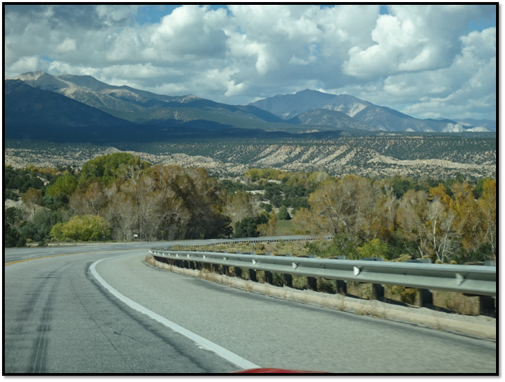 A road with trees and mountains in the background

Description automatically generated with medium confidence