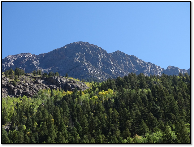 A mountain with trees in front of it

Description automatically generated with low confidence