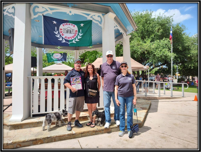 A group of people standing in front of a gazebo

Description automatically generated