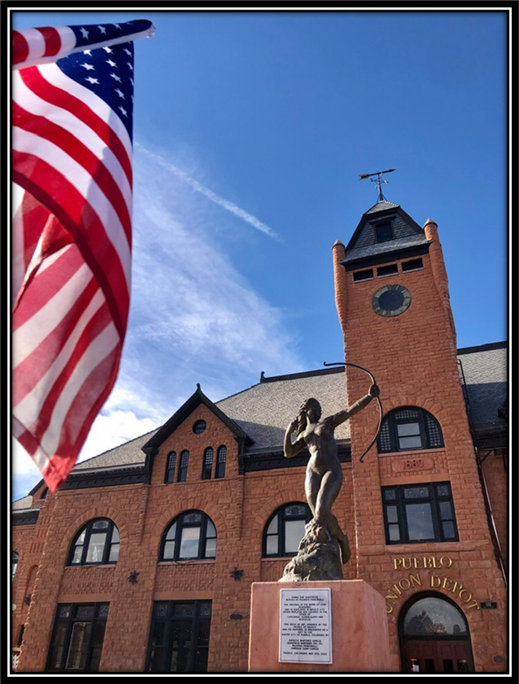 A statue in front of a building with a flag on top

Description automatically generated with medium confidence