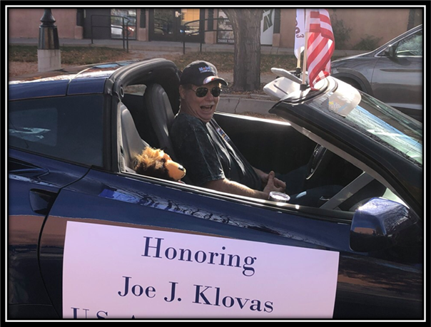 A person in a car with a sign in front of him

Description automatically generated with low confidence