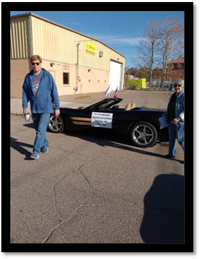 A person walking next to a black car

AI-generated content may be incorrect.